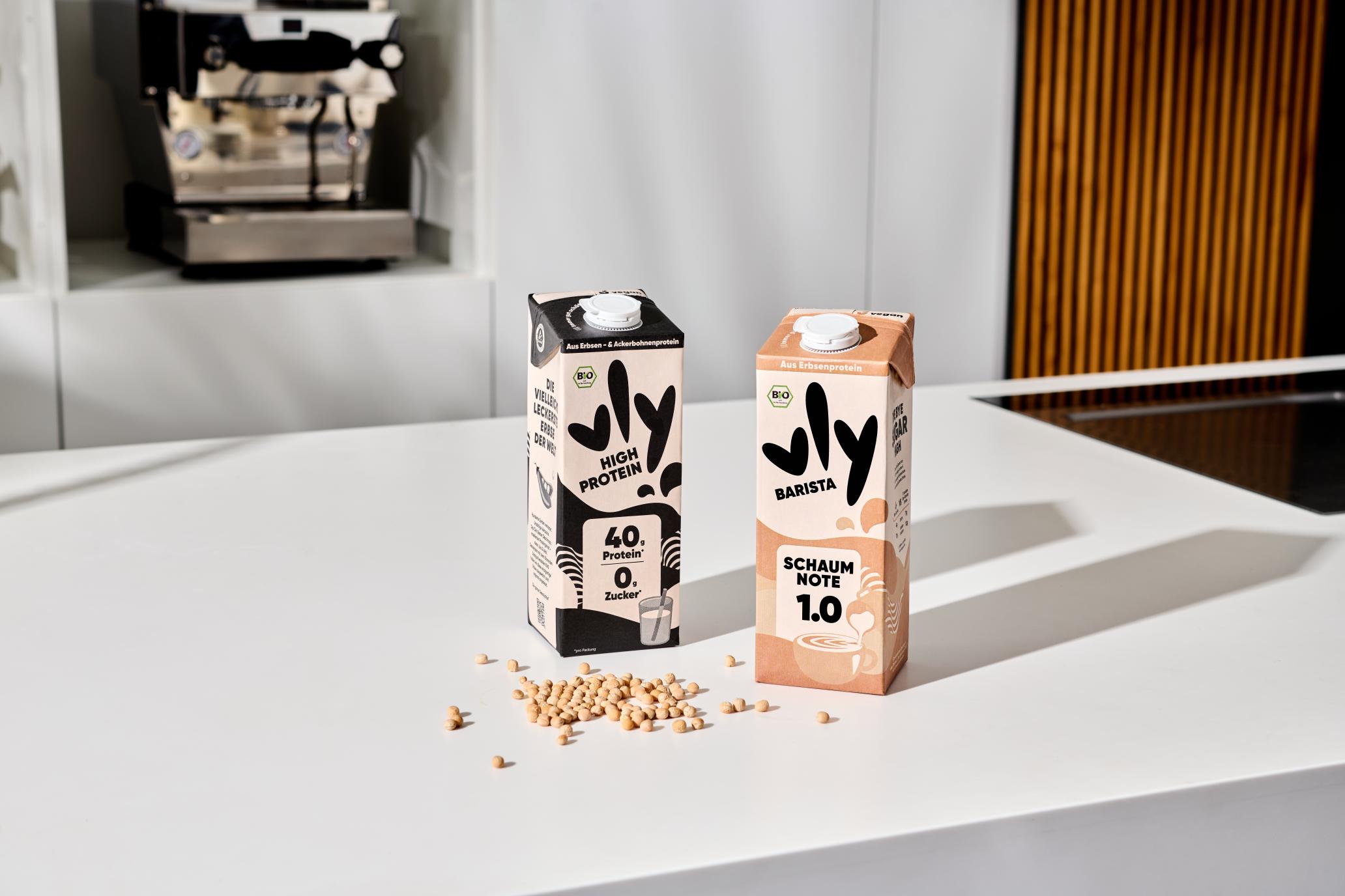 vly milk packages, high protein and barista edition with peas on a table